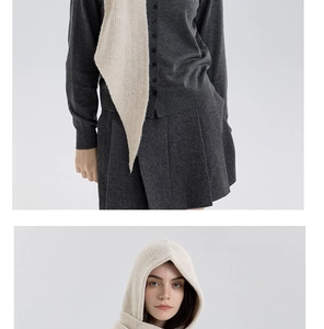 Detailed knit texture of beige hooded scarf paired with dark grey cardigan and skirt