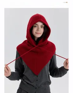 Detail of red ribbed knit balaclava showing thick texture and functional drawstring closure