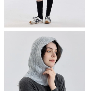 Macro detail of light grey cable knit wool balaclava featuring thick textured patterns