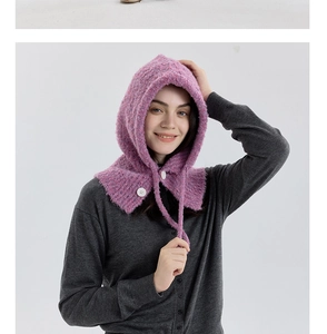 Close-up of fuzzy purple bouclé knit Balaclava with a prominent white round button detail