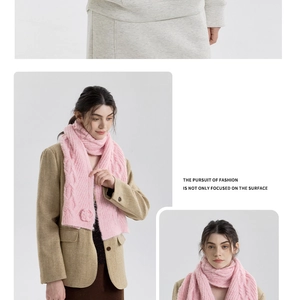 Pink chunky cable knit scarf featuring a knitted rose flower detail and thick texture