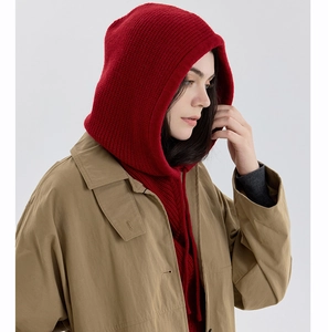 Detail of red knit balaclava showing thick texture and functional drawstring hood