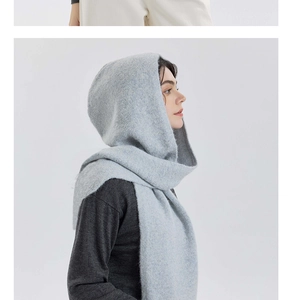 Detailed texture of dusty blue knitted hooded scarf with plush mohair wool blend fabric
