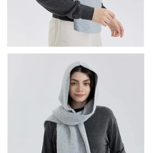Close-up texture and styling of light blue knitted hooded scarf for cold winter warmth