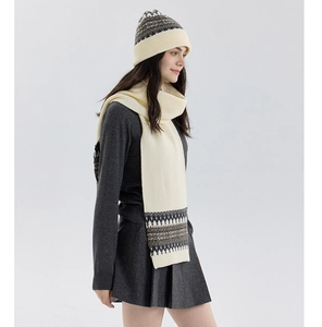 Detail of white Fair Isle knit scarf and beanie set with Nordic geometric patterns
