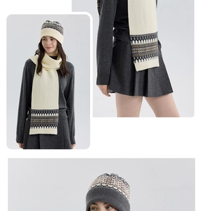 Detail of Nordic Fair Isle knit scarf and beanie set in cream and dark grey patterns