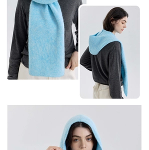 Close-up of light blue knitted hooded scarf showing soft texture and cozy hood design