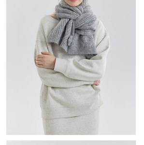 Detail of chunky knit scarf in dark grey featuring premium cable stitch and ribbed texture
