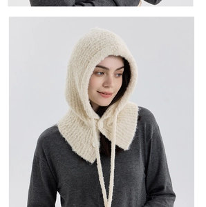 Detailed view of the chunky knit balaclava showing button closure and woven drawstrings