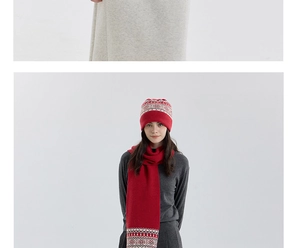 Detail of red Nordic Fair Isle knitted scarf and beanie set with snowflake patterns