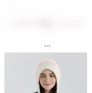 Detailed view of pink and white checkered knit earflap hat with warm fuzzy texture