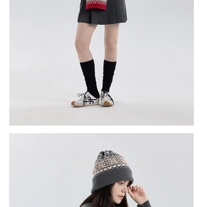Detail of Nordic Fair Isle knit hat with gray geometric pattern and matching winter accessories