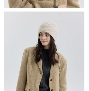 Detailed view of the soft ribbed texture on this thick cream white wool knit beanie hat