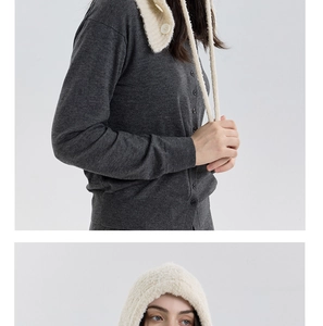 Detail of grey wool cardigan and cream bouclé knit balaclava with button closure