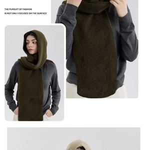 Close-up of a dark forest green knitted hooded snood scarf with textured fleece finish