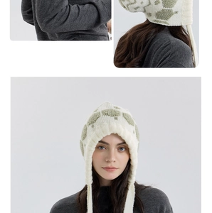 Detail of snowflake knit beanie with earflaps and green geometric turtle pattern