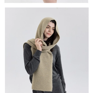 Detail of soft beige knitted hooded scarf showing thick plush texture for winter warmth