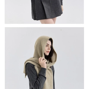 Detailed knit texture of oatmeal hooded scarf wrap paired with grey pleated wool skirt