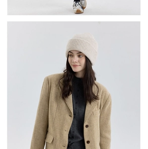 Detailed texture of off-white double-layered wool blend knit beanie with ribbed pattern