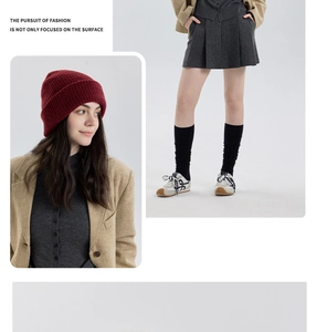 Winter lifestyle shot of a burgundy thick wool knit beanie for men and women