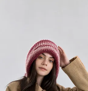 Close-up of knit texture on winter balaclava hood with purple and beige gradients