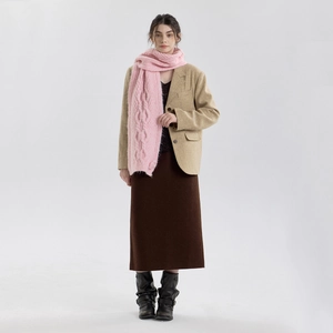 Pink chunky cable knit scarf paired with brown wool blazer and long skirt for winter style