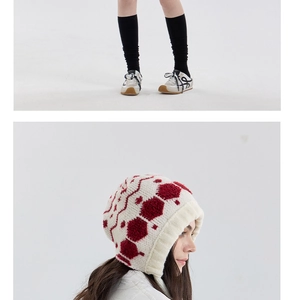 Close-up of winter knit hat featuring vintage red geometric patterns and premium texture