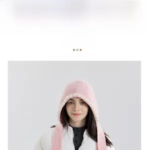 Close-up of pink knitted hooded scarf with elegant faux pearl embellishments and soft texture