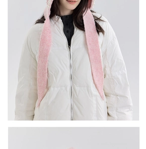 Detail of a pink knit hood with elegant pearl accents worn over a white quilted puffer coat