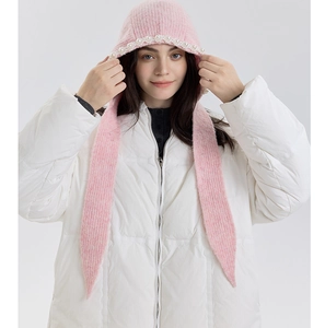 Detail of pink knitted hood with white pearl trim and adjustable tie straps for winter