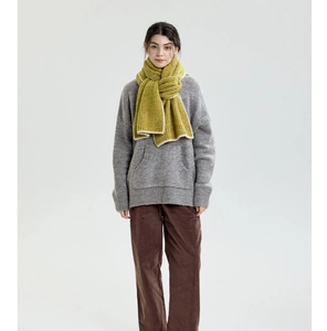 Winter outfit styling featuring a grass green ribbed knit scarf with contrast piped edges