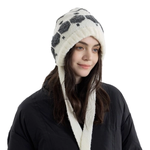 Winter knitted trapper hat with snowflake patterns and ear flaps featuring long ties
