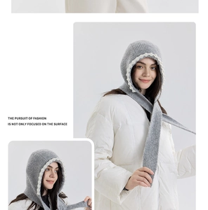 Detailed view of grey knitted balaclava with white pearl trim and ribbed texture details