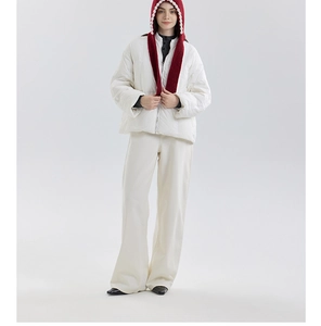 Close-up of deep red knitted hooded scarf with white lace trim and white puffer jacket