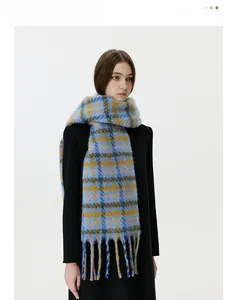 Macro view of plaid winter scarf with thick mohair texture and long tassel details
