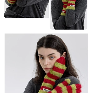 Detail of red and green striped plush knit gloves with tactile furry texture and cuff label