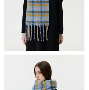 Close-up of houndstooth scarf with long tassels showing fuzzy mohair texture and drape
