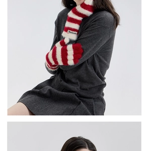 Detail of red and white striped plush knit fingerless gloves with soft faux mink texture