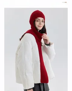 Detail of red ribbed knit balaclava scarf showing texture and soft material on a model
