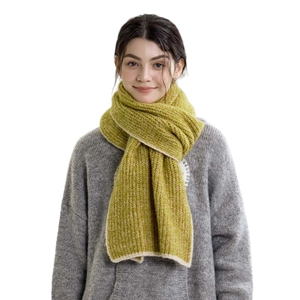 Mustard yellow ribbed knit scarf worn by a model in a cozy winter style