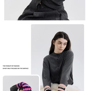 Detail of pink and black striped plush arm warmers with a knitted sweater for winter