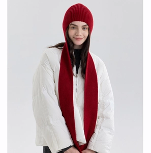 Detailed view of red ribbed knit hooded scarf styled with a white winter puffer jacket