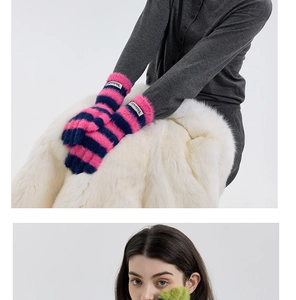 Detail of pink and blue striped faux fur gloves with brand tag for winter warmth