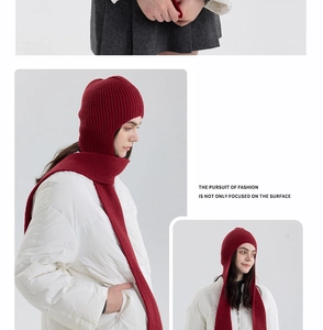 Detail view of burgundy ribbed knit hooded scarf showing premium texture and layered styling