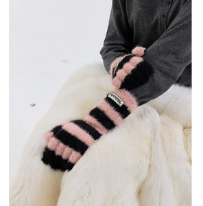 Detail of pink and black striped plush knit gloves with fuzzy mink-like texture