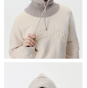 Detail of grey knitted balaclava with drawstring and cream sweatshirt embroidery