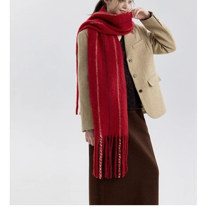 Macro shot of the soft wool blend texture and long fringe details on the red striped scarf