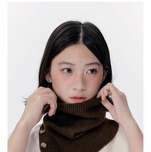 Detail view of dark brown ribbed knit neck warmer with button closure for winter