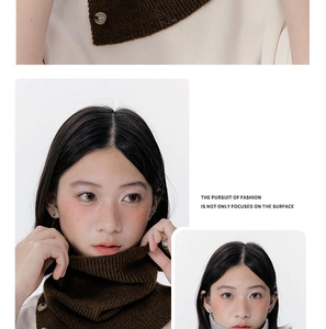 Detail of dark brown knitted neck warmer showing textured stitching and button closure
