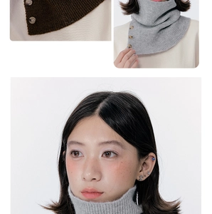 Detail of knitted neck warmer with vertical stripes and vintage wood style buttons